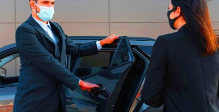 Airport transfers NYC showing yellow taxi and shuttle bus at JFK terminal with travelers and luggage